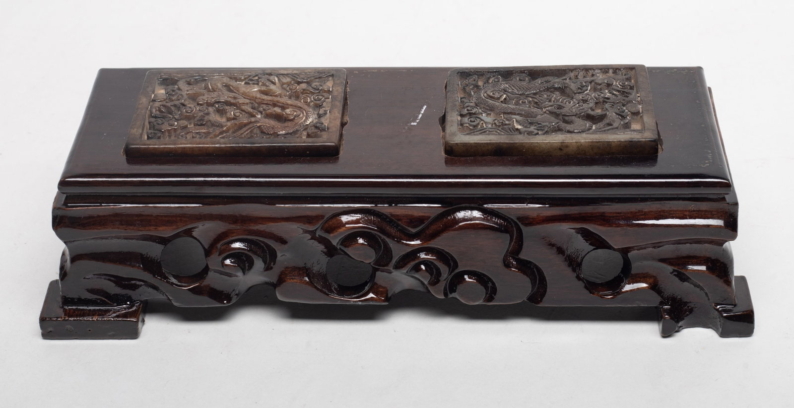 Chinese Jade Belt Buckle on Wood Base: Two Chinese jade belt buckles carved in openwork with dragons among clouds, with wood base. Approx. 8.4*3.4*2.3 inch (base size).