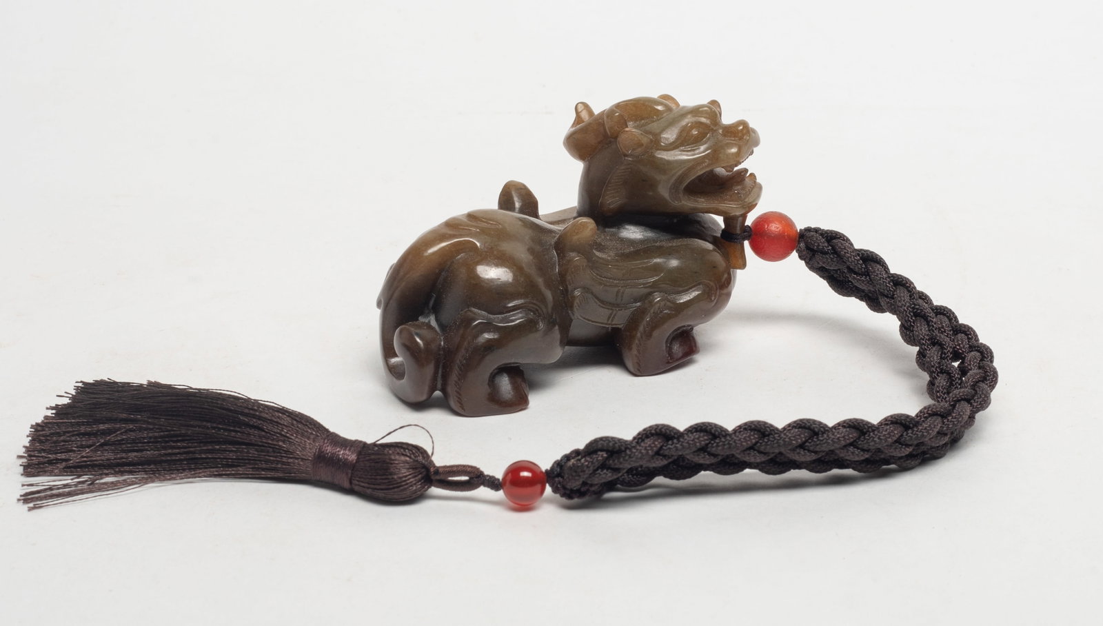 Chinese Jade Carved Beast Pendant: Chinese russet jade carved ferocious beast pendant, with bead and string. Approx. 3.2*2*1.65 inch.