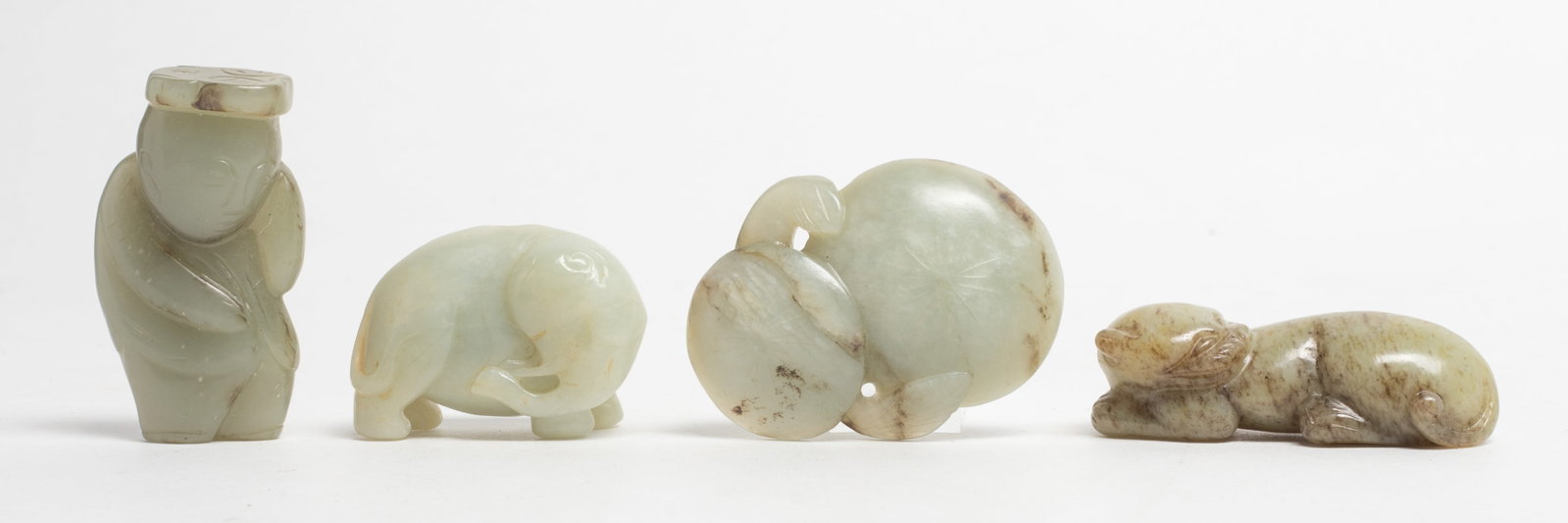 Set Chinese Export Jade Toggles, Pendants: Set of four Chinese jade toggles carved in form of beast, elephant, mushroom or boy. Approx. 2*1.45 inch (largest).