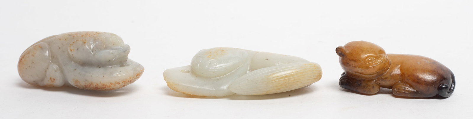 Chinese Russet Jade Carved Beast Pendants: Three Chinese russet jade pendants carved of recumbent beast form. Approx. 2.63*1.47*0.65 inch (largest).