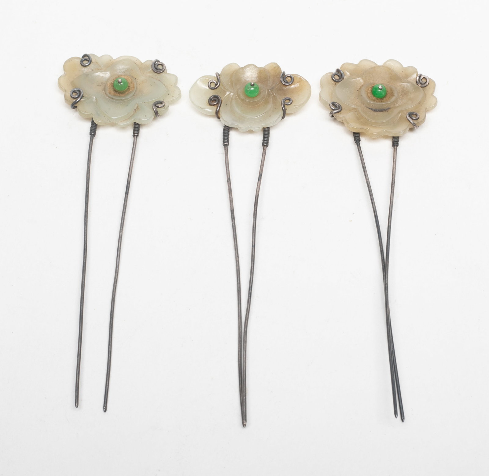 Chinese Jade, Sterling Silver Hair Pins: Set of three Chinese flower form jade and sterling silver hairpins. Approx. 4.1*1.25 inch (largest).