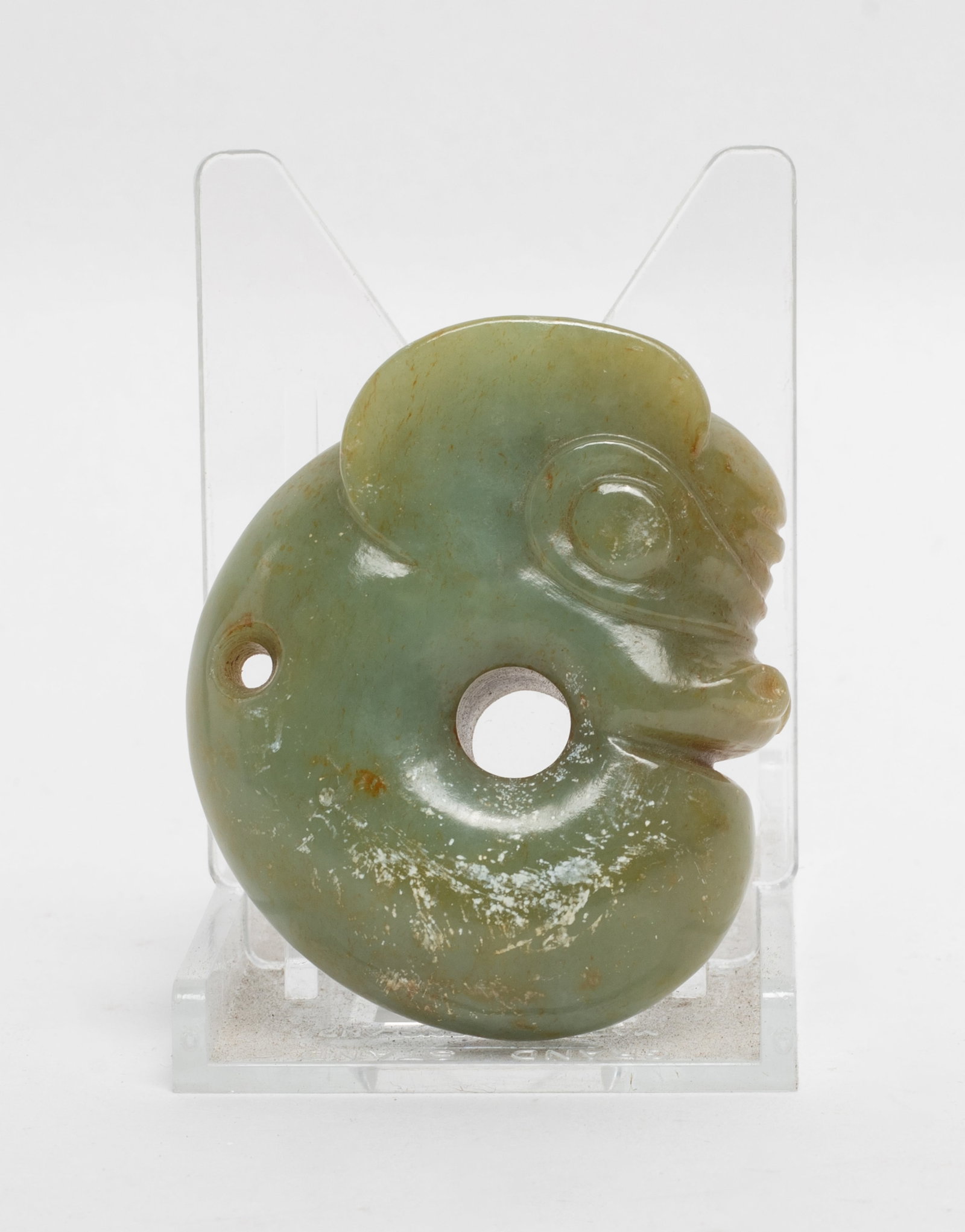 Estate Chinese Jade Carved Pendant: Carved as a stylized coiled dragon with its tail curving towards the head, the head detailed with incised round eyes and a flat mouth below pricked ears, drilled with a circular aperture to the
