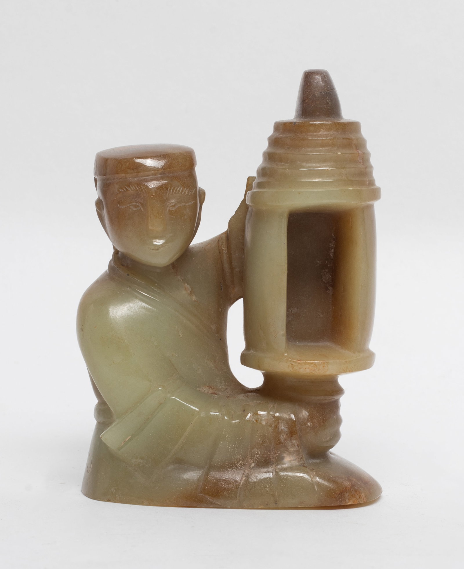 Chinese Jade Carved Table Sculpture: Depicts a kneeling figure dressed in a traditional robes and wearing a flat topped cap, with one arm extended upward to hold a lantern. Approx. 3.7*2.59*1.67 inch