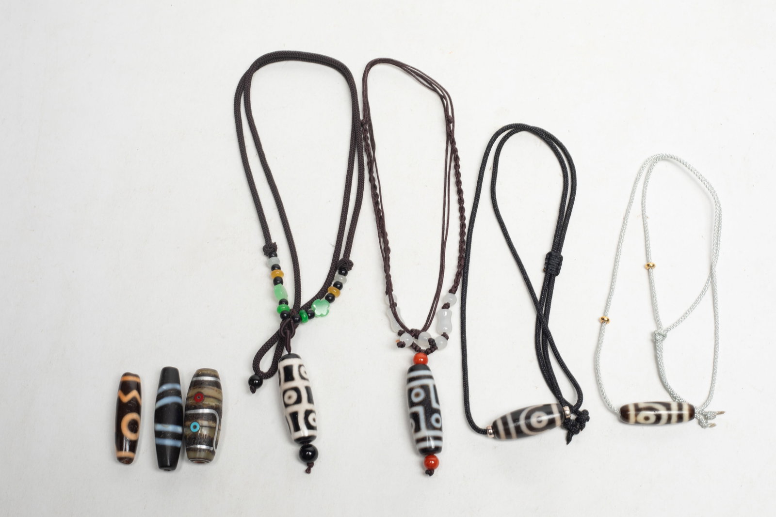Set Chinese Sino-Tibetan Dzi Beads: Group of seven Chinese sino-tibetan dzi beads. Approx. 1.8*0.5 inch (larger)