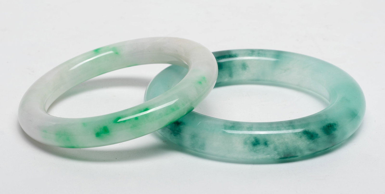 Two Chinese Colored Stone Bangles: Two Chinese colored stone bangles. Approx. 2.34 inch inner diameter(larger); 3.43 outer diameter (larger)