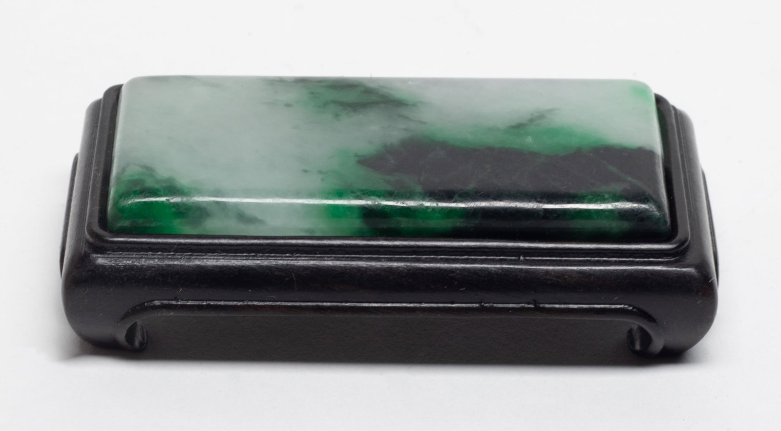Chinese Wood Inlaid Colored Stone Stand: Chinese wood stand inlaid with a rectangular form colored stone. Approx. 1.85*3.47*1.02 inch