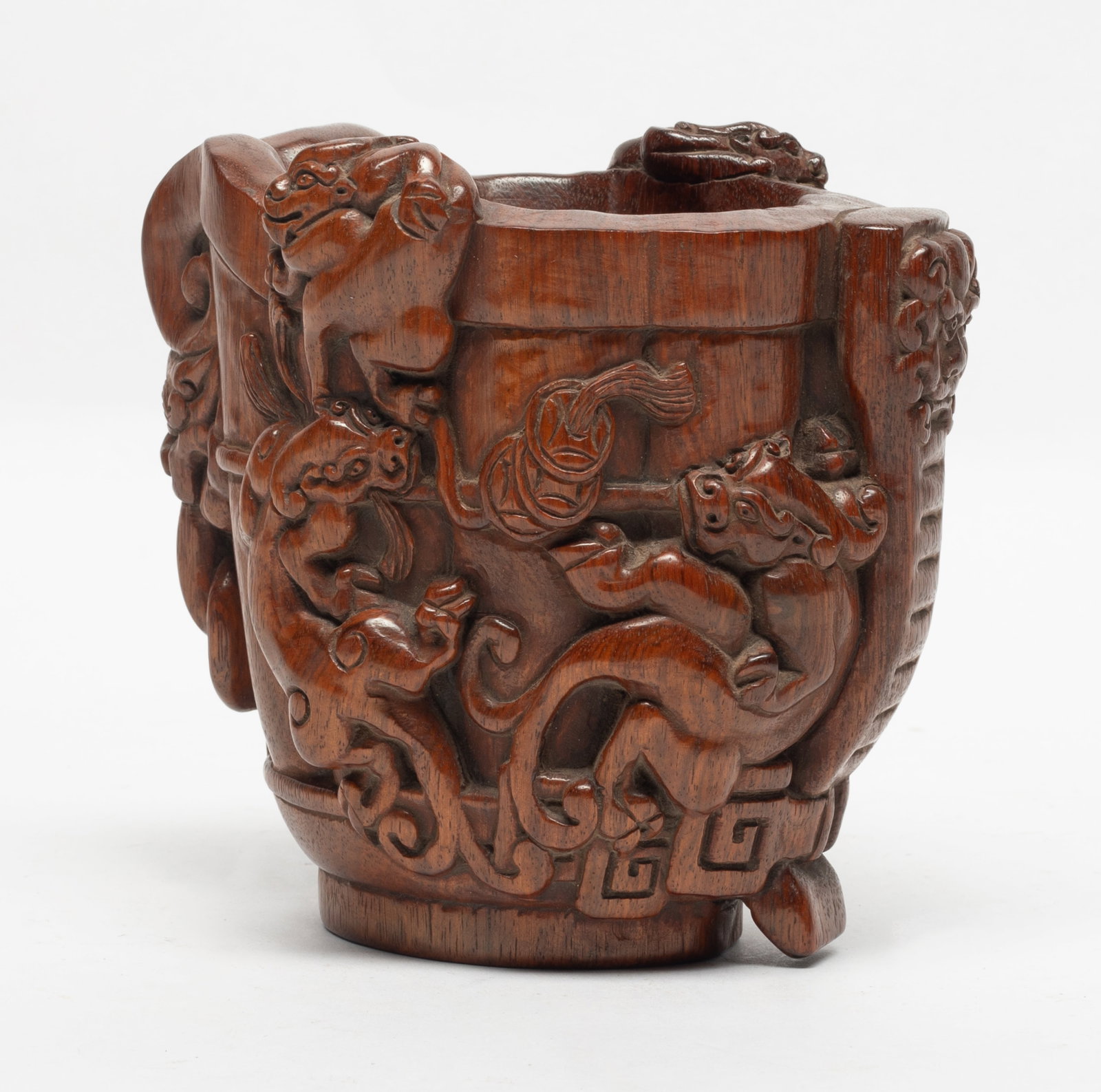 Chinese Boxwood Libation Cup: The tapering deep walls formed of overlapping petals rising to the slightly flared undulating rim, finely carved in relief with beast pattern. Approx. 5.1*5.37 inch