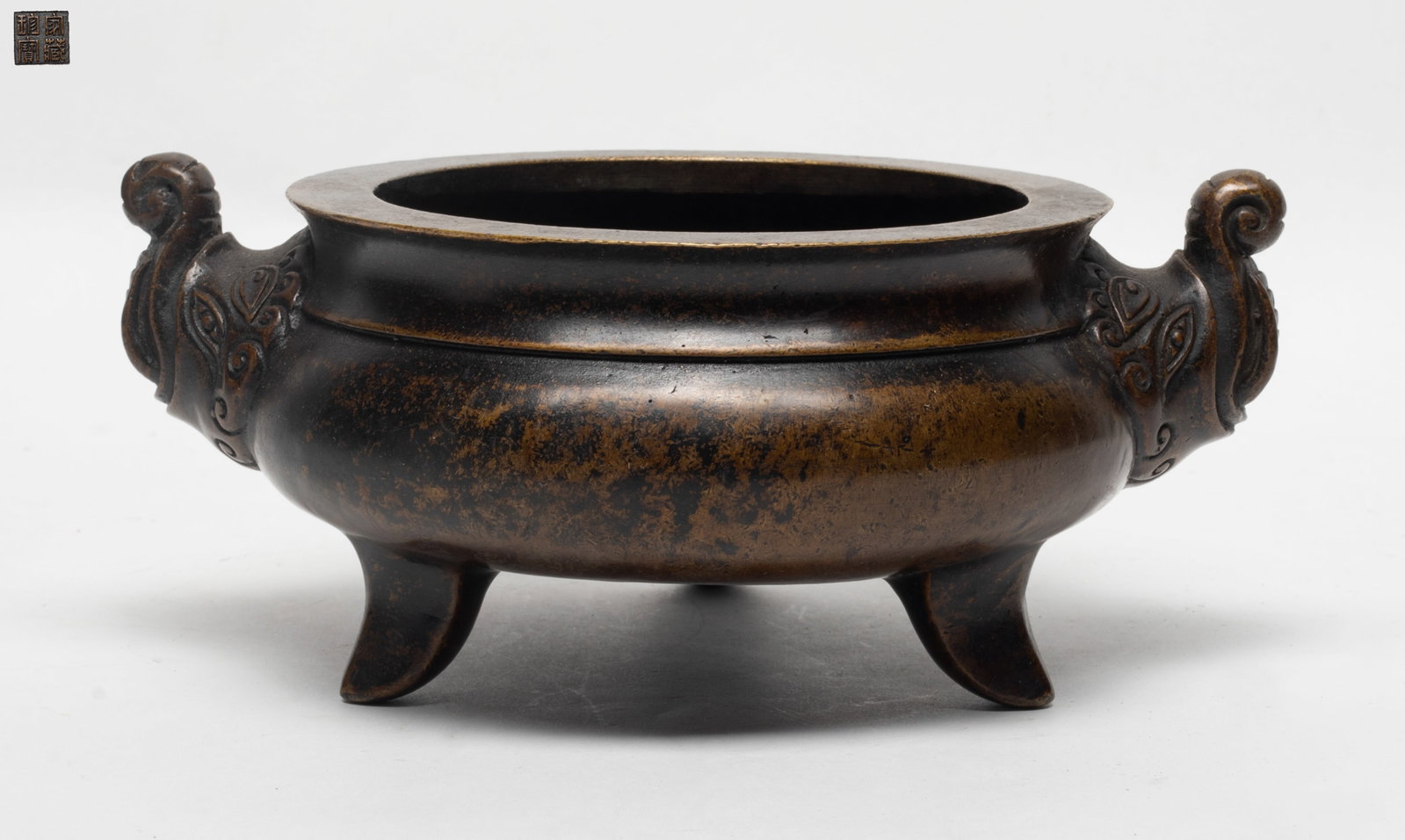 Estate Chinese Bronze Cabinet Censer: The cabinet censer of globular body supported on a tripod feet, flanked with a pair of elephant head handle, the base incised with a mark. Approx. 8.8*3.6 inch