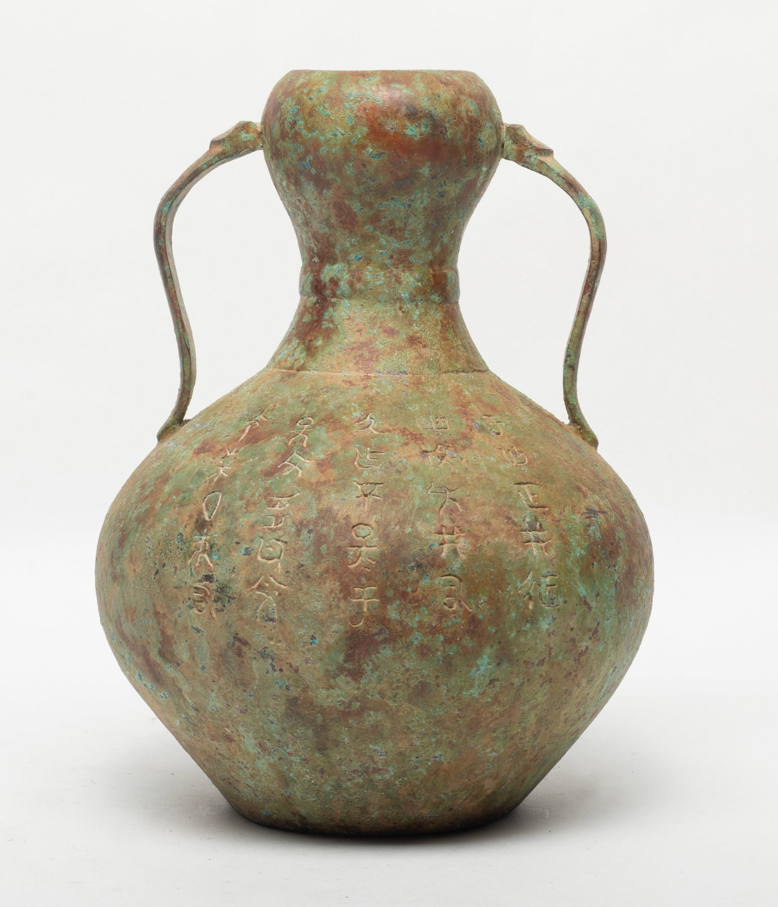 Estate Chinese Bronze Vase: The globular body rising to a waisted neck set with a pair of handles at the shoulder, the exterior incised with ancient character. Approx. 9.1*6.5 inch