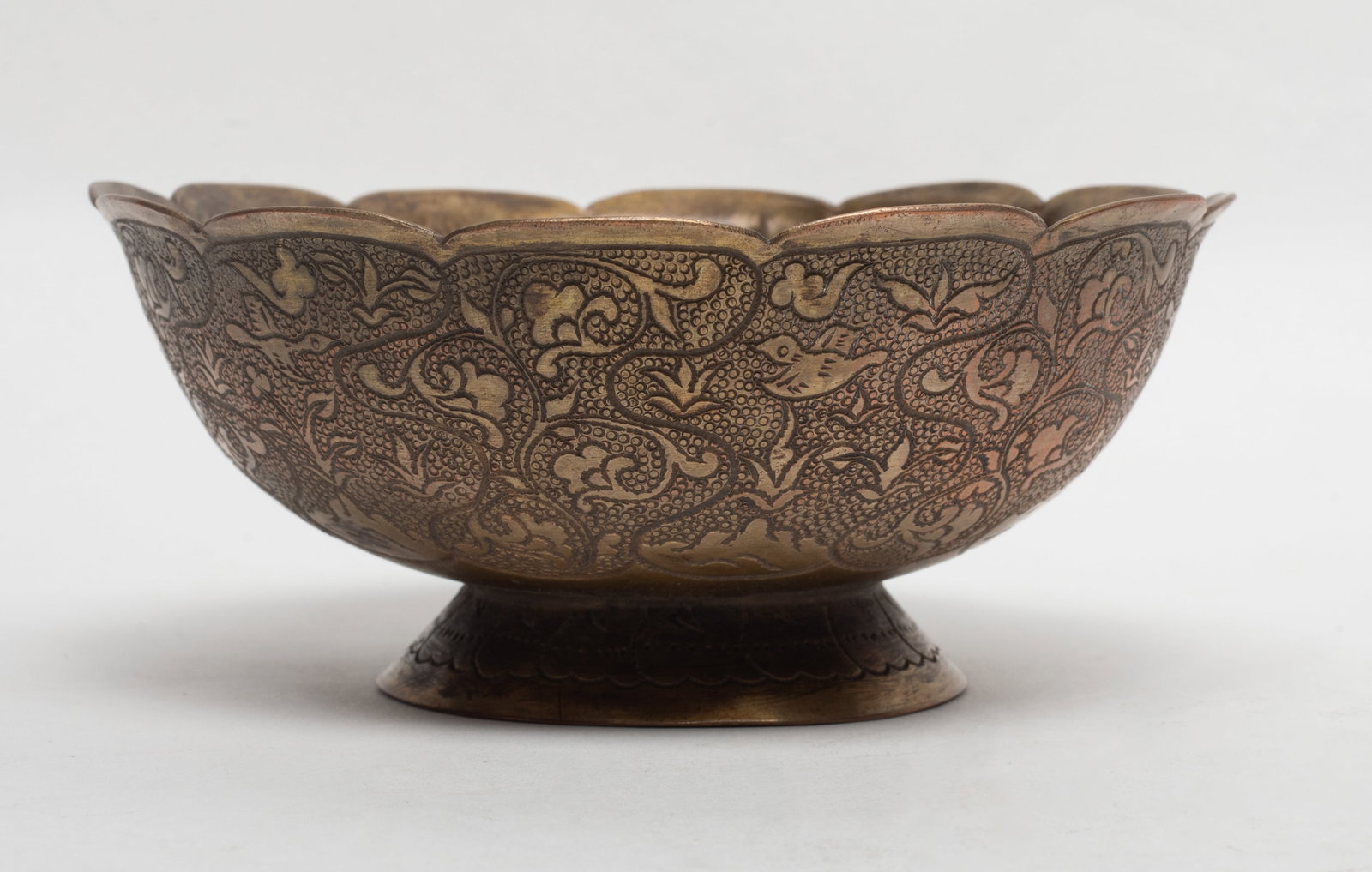 Chinese Early Style Gilt Cup: The gilt cup supported on a tapered foot raised to a lobed rim, the exterior incised with floral scroll pattern. Approx. 5*2.1 inch