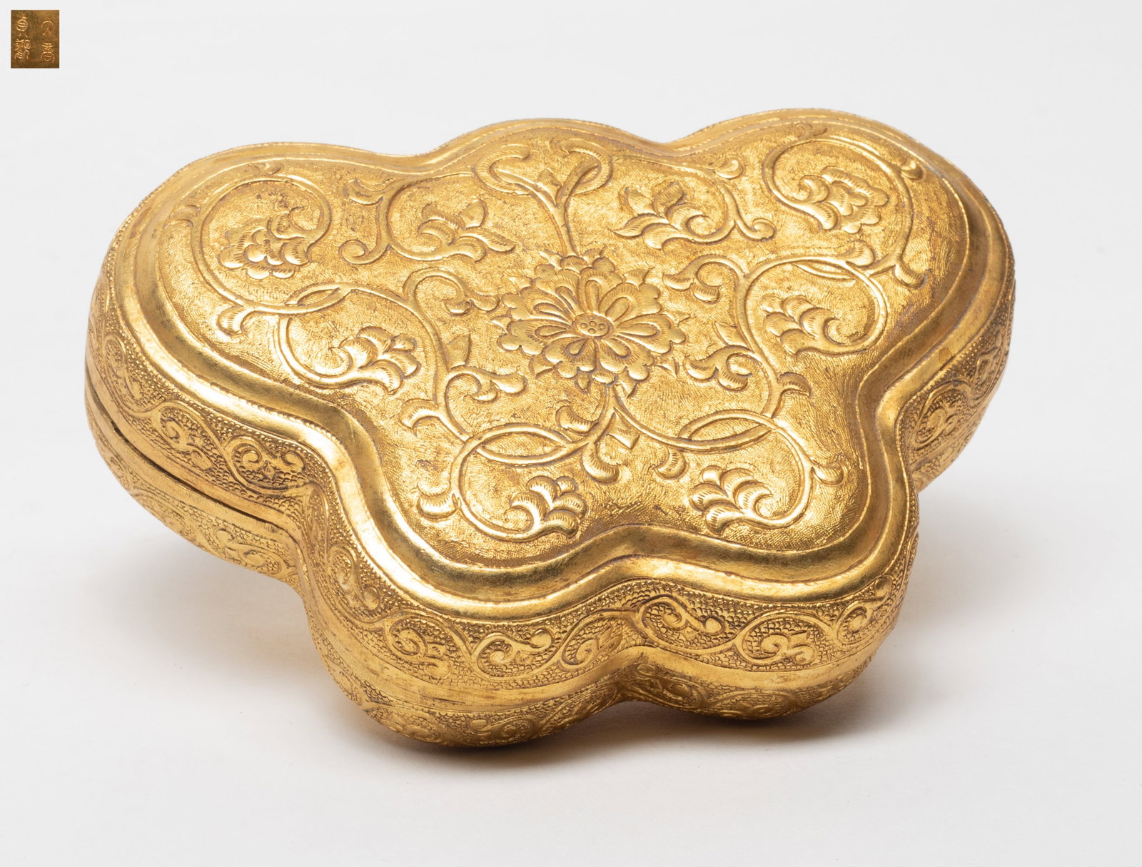 Chinese Gilt Bronze Covered Box: Chinese gilt bronze covered box, in the shape of butterfly, carved with blossom floral scroll, the base incised with a four-character. Approx. 5*1.4 inch