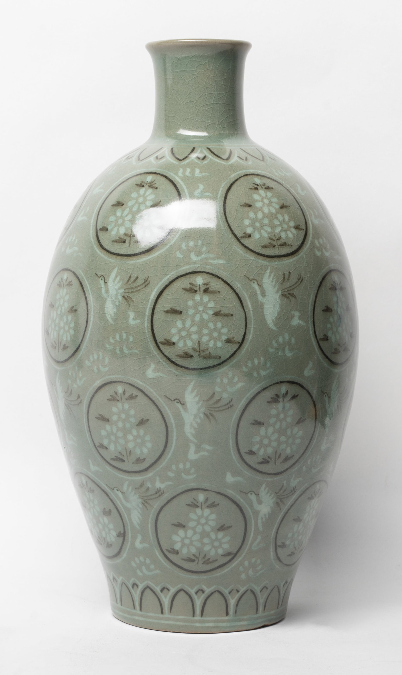 Tall Korean Porcelain Vase: The ovoid body rising to a waisted neck and a flared neck, painted with cranes amidst clouds on a celadon ground. Approx. 12.7*6.4 inch
