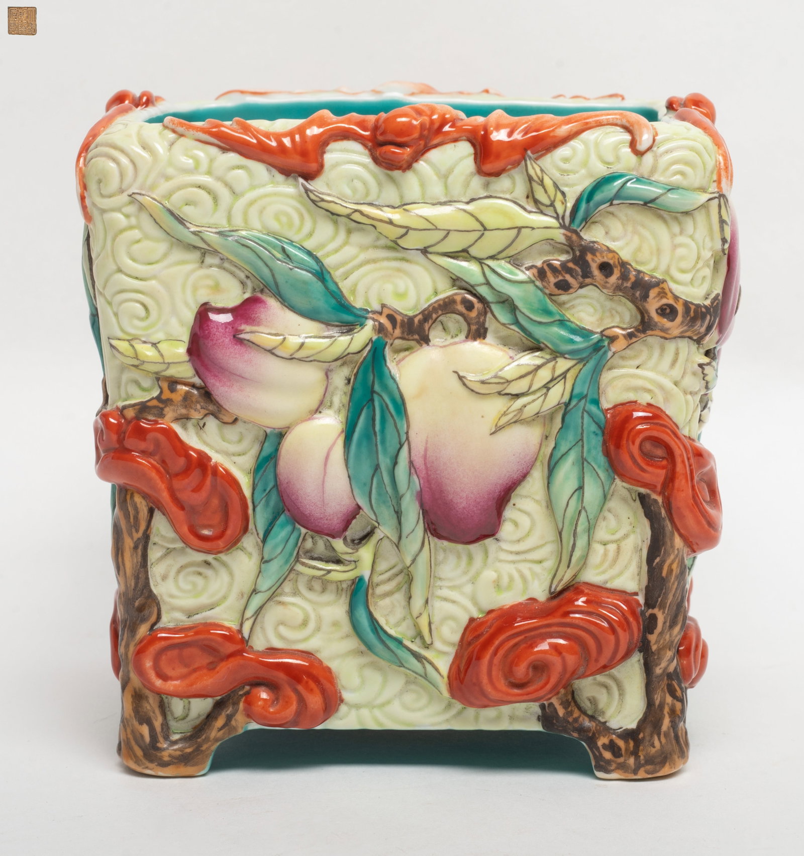 Chinese Famille Rose Porcelain Brush Pot: Chinese famille rose porcelain brush pot, carved in high relief of the peach stem pattern, the rim highlights with bats, the base incised with a seal mark. Approx. 5.1*4.6 inch