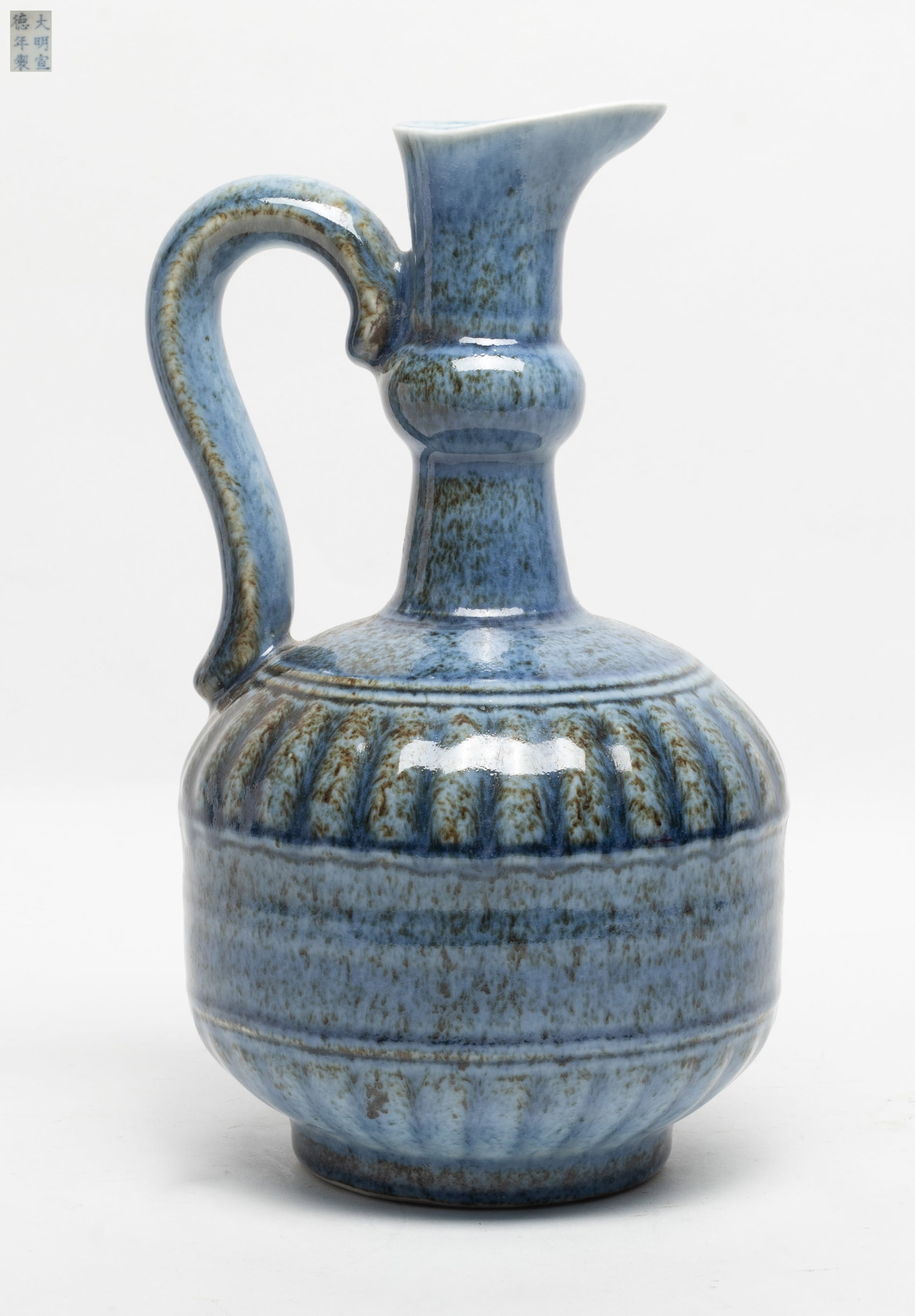 Chinese Flambe Glazed Porcelain Pot: Chinese flambe glazed porcelain pot applied overall in blue glaze suffused with brown color, the base inscribed with a six-character. Approx. 10.9*6.3 inch