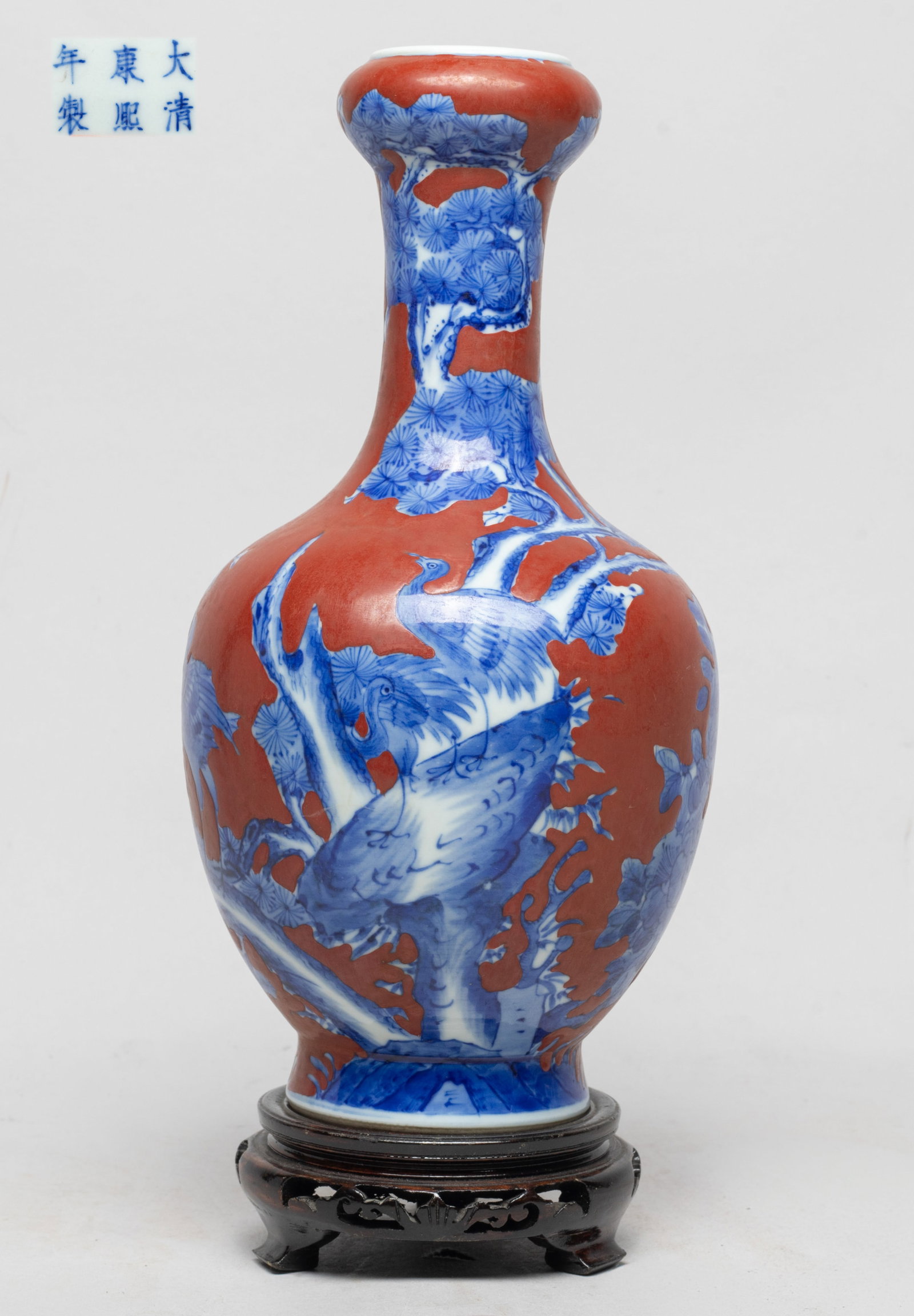 Estate Chinese Export Porcelain Cabinet Vase: The ovoid body rising from a splayed foot to a cylindrical neck and a garlic mouth, the exterior painted with birds, pine tree and peony against red glazed background, the bottom marked with six chara
