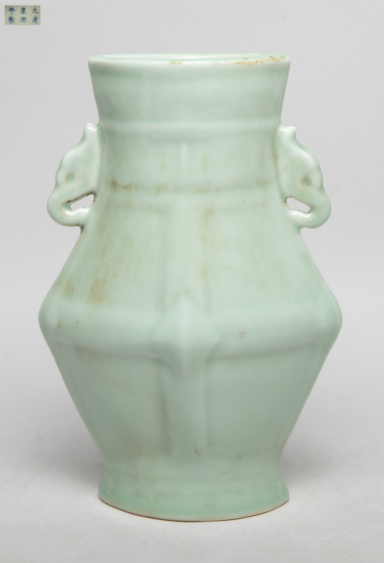 Estate Chinese Green Glazed Porcelain Vase: Special form Chinese porcelain vase, the body moulded with raised crossing bands, flanked by a pair of stylized handles, overall covered with pale green glaze, the bottom marked with six characters.