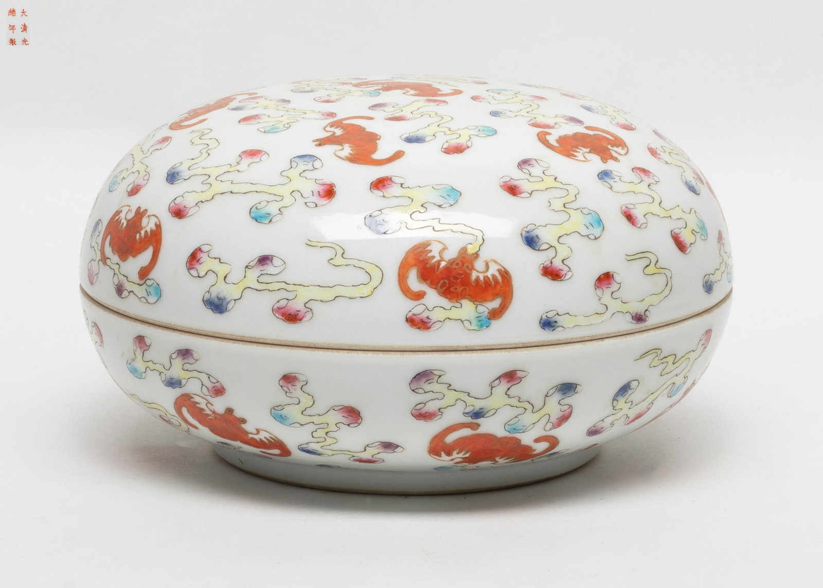 Large Chinese Famille Rose Porcelain Covered Box: Large Chinese famille rose porcelain covered box, the exterior surface painted in iron-red tone of bats flying amidst clouds pattern, the base inscribed with a six-character reign mark. Approx. 7.1*3.