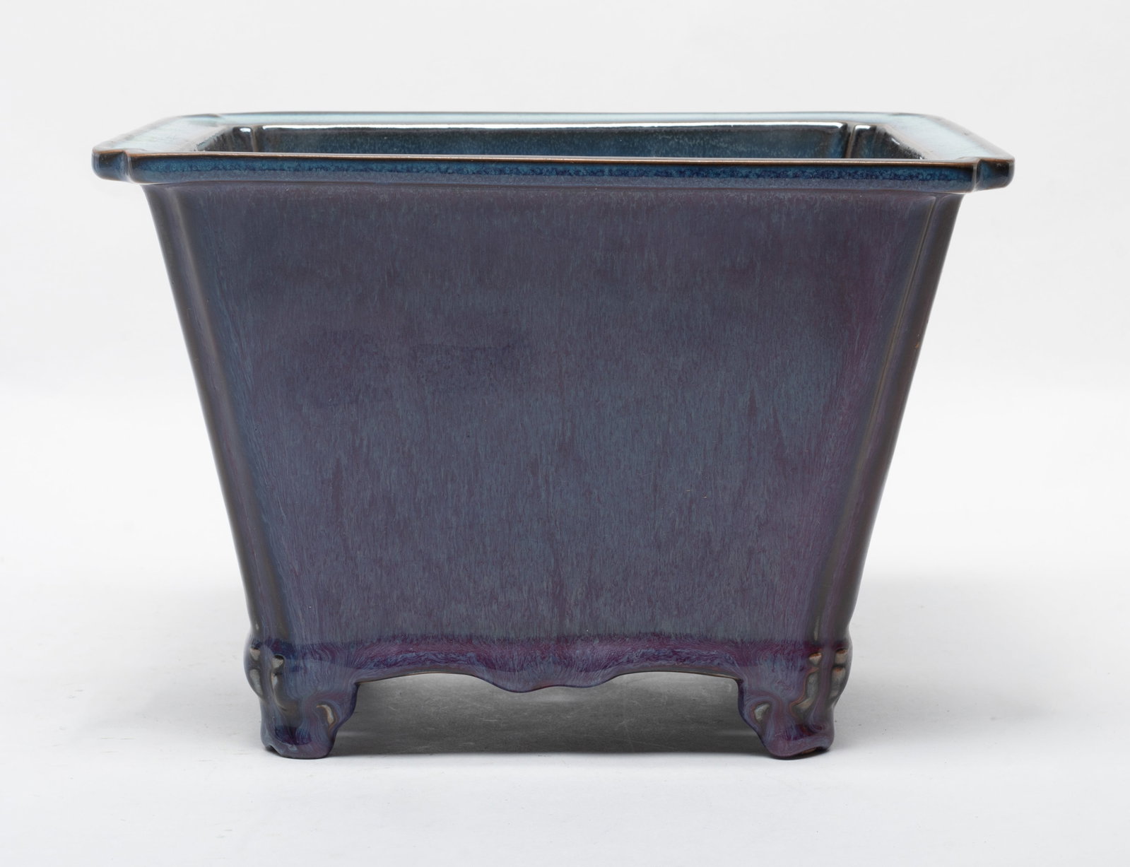Large Chinese Jun Type Porcelain Pot: Molded in square form, the interior applied in crackled blue glaze and the exterior in streaked purple glaze, the bottom pierced with five apertures. Approx. 9*6.1 inch.