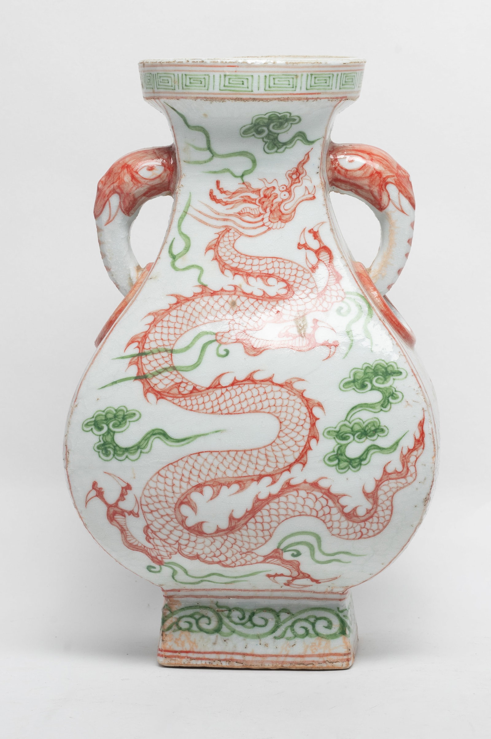 Chinese Red & Green Glazed Porcelain Vase: The bulbous body tapering to a square base, the body flanked with a pair of beast handle, each side painted with red and green glaze of the dragon pattern, the glaze stop at the foot. Approx. 10.6*6.3