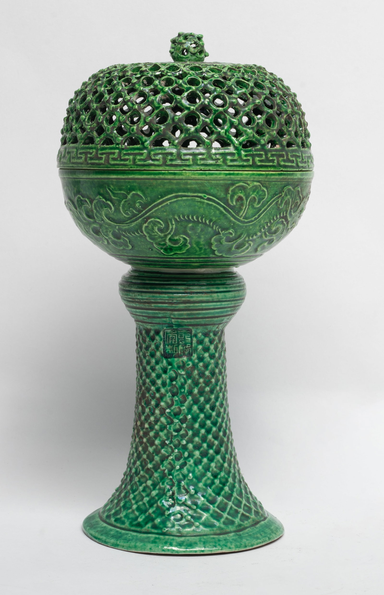 Chinese Turquoise Glazed Porcelain Piece: Overall applied in a turquoise glaze with openwork fitted lid, the tall slender body incised with a seal mark and floral pattern. Approx. 10.7*5.3 inch