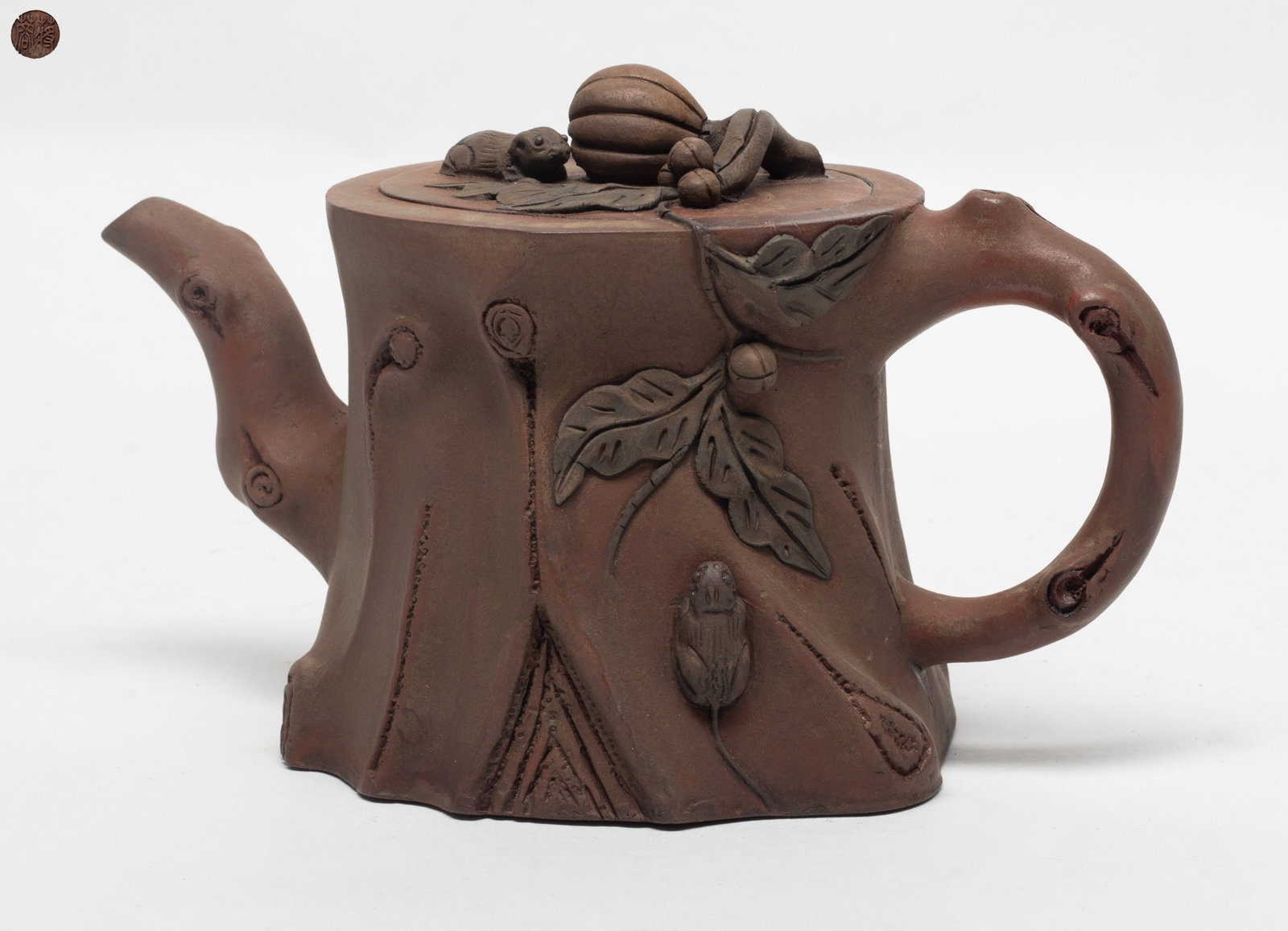 Chinese Export Yixing Zisha Tea Pot: Molded in form of adjacent tree trunk, the cover and side carved with squirrels and pumpkin in high relief, the base inscribed with a mark. Approx. 4.1*7.1 inch