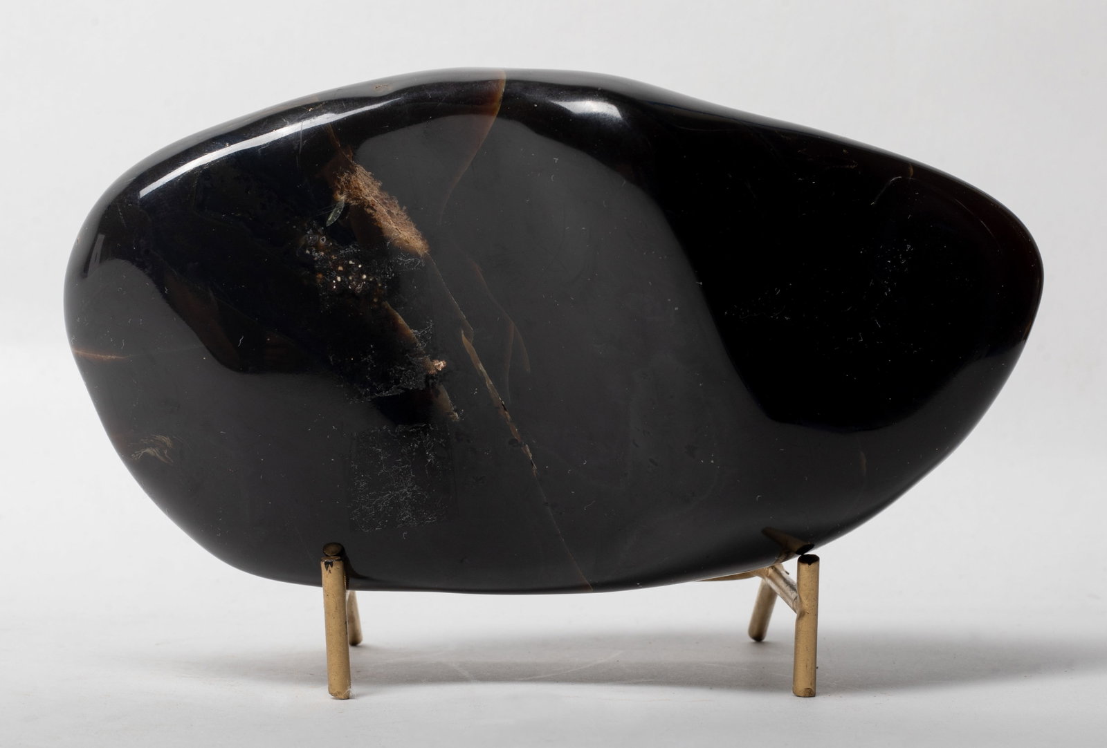 South Asian Root Amber Sculpture: South Asian root amber sculpture, well polished, with metal stand. Approx. 6.8*3.5 inch; 565 gram