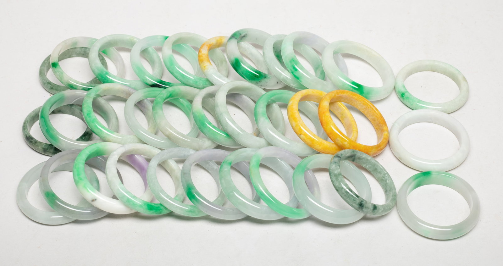 Estate Large Set Chinese Export Bangles: Large set of Chinese colored stone bangles. Size varies. The Estate of the Heritage & Moving Sale. Pasadena, CA, 2025.