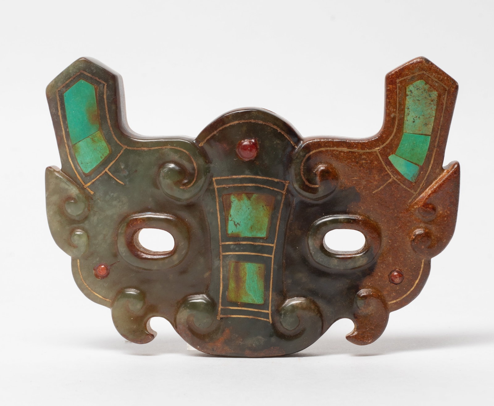 Large Chinese Jade/ Stone Carved Plaque: Large Chinese jade/stone plaque, carved in the form of archaistic mask, inlaid with gemstone. Approx. 3.48*2.39 inch