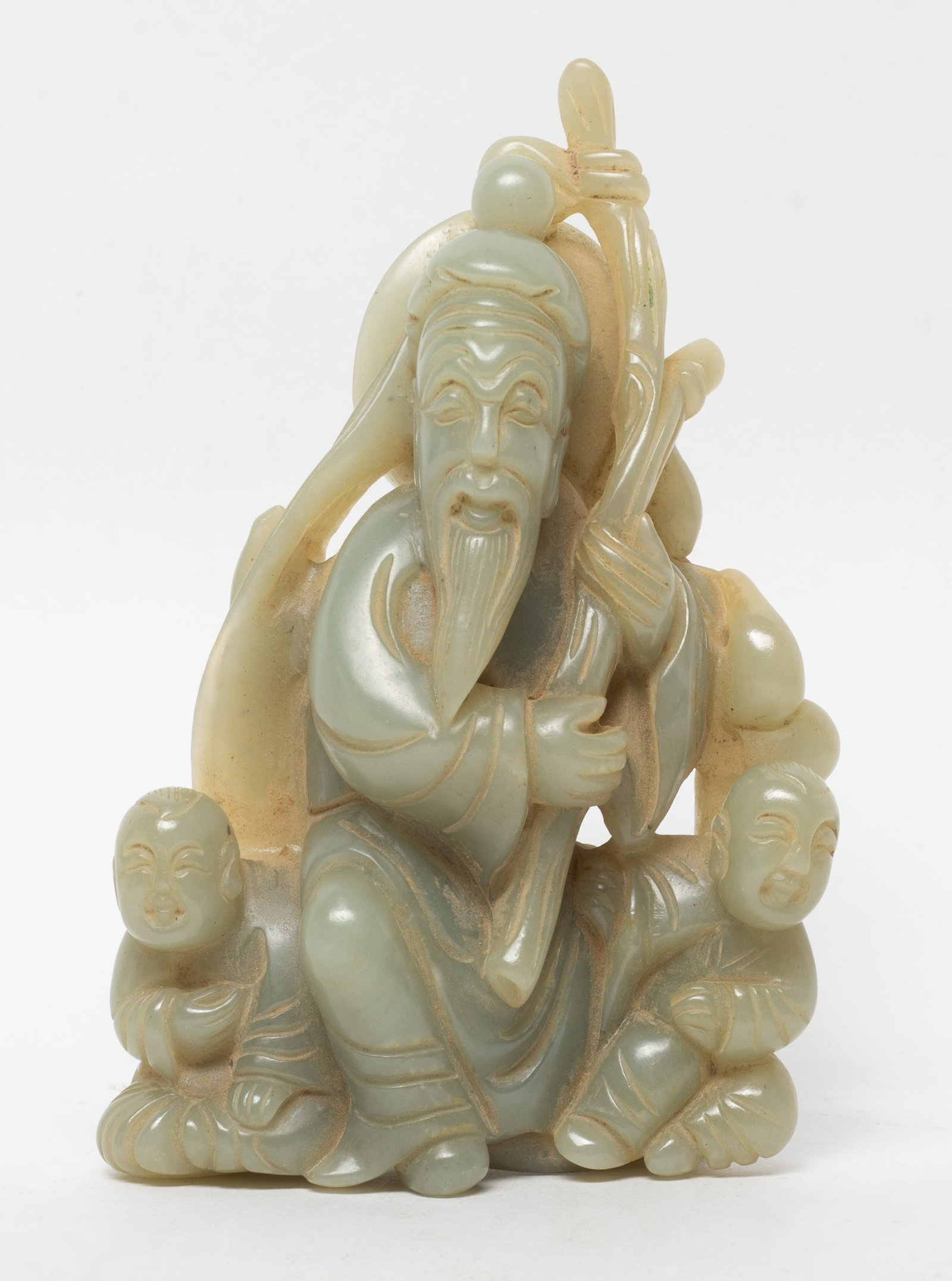 Large Chinese Jade Carved Sculpture: The jade sculpture depicts a figure wearing long, flowing robes, in a seated position, holding a long scepter, two children on his each side. Approx. 4.99*3.13 inch