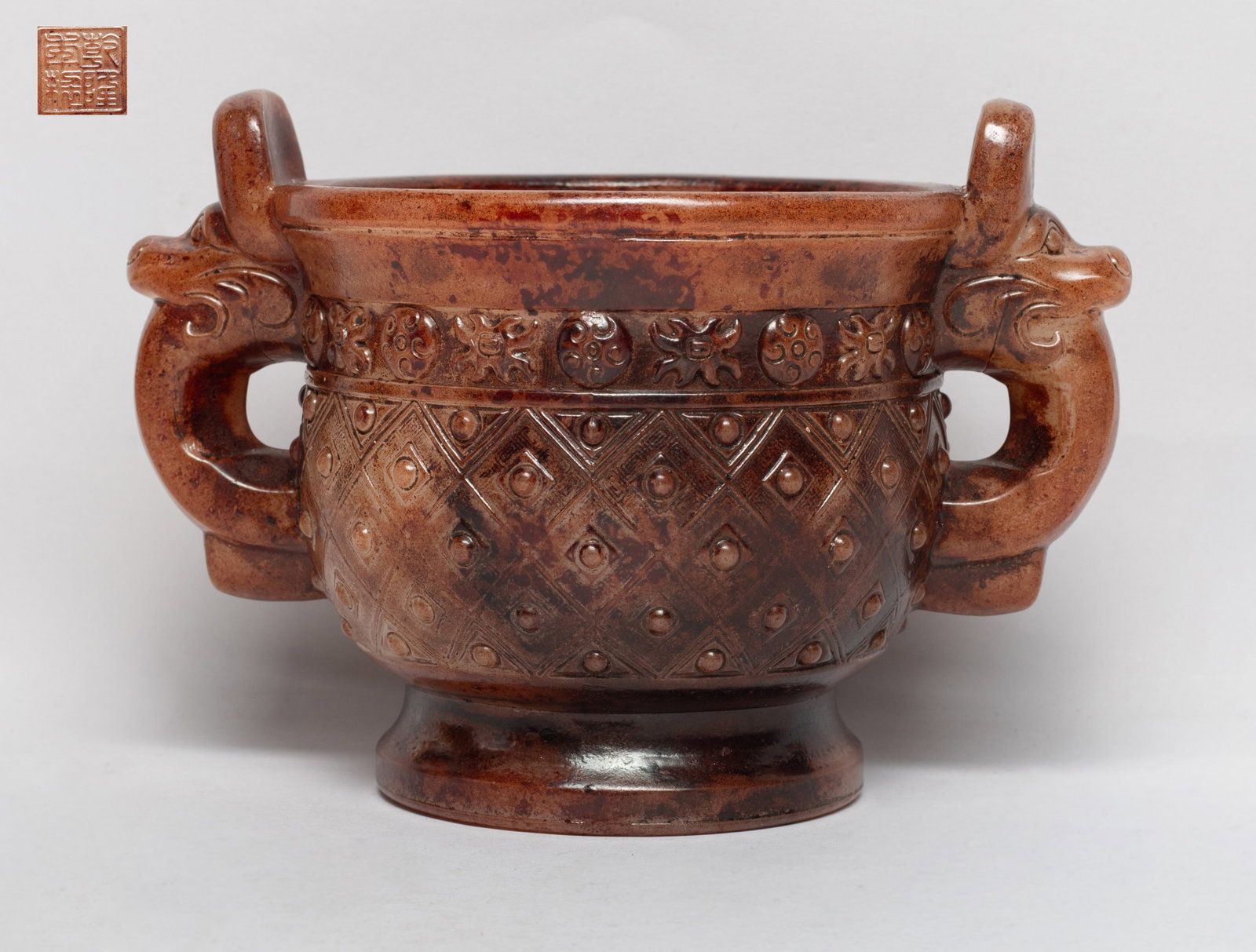 Estate Chinese Export Libation Cup: Of deep U-shape rising from a splayed foot to a flared rim, flanked by two handles issuing from beast heads, the exterior carved a wide band of raised bosses under a band of stylized flowers, the bott