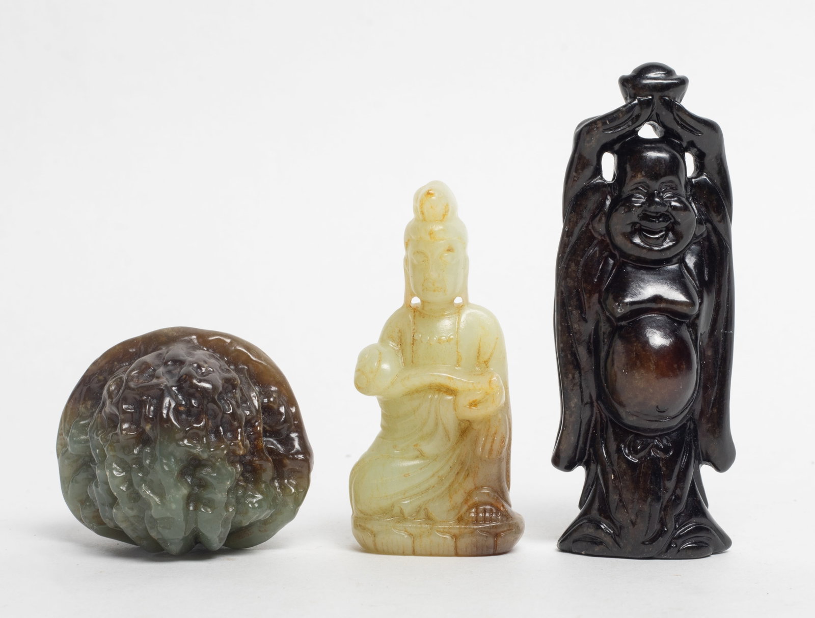 Set Chinese Jade/ Hard Stone Carvings: Set of three Chinese jade / hard stone carvings, wherein two of Buddha form and the other of nut form. Approx. 1.82*1.75*1.55 inch (nut size).