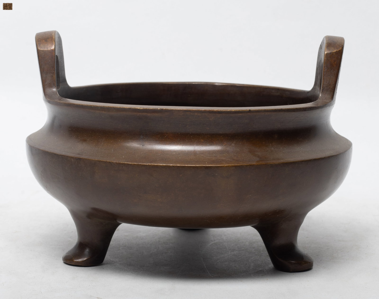 Large Chinese Bronze Censer: The compressed globular body surmounted by a pair of pierced upright handles, supported with three feet, base incised with a two-character mark. Approx. 6.6*4.8 inch