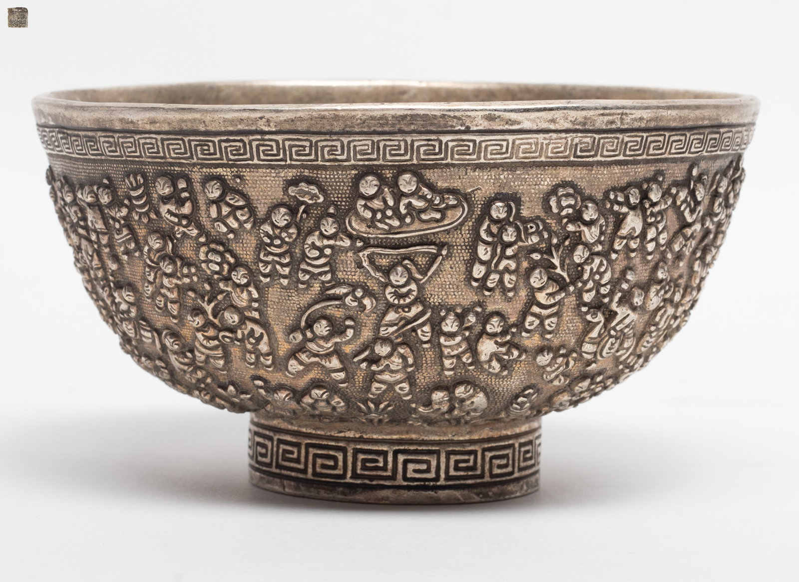 Estate Chinese Silver Tone Bowl: Estate Chinese silver tone bowl, the exterior carved with multiple figures in various position, the base inscribed with a four-character mark. Approx. 5.04*2.77 inch