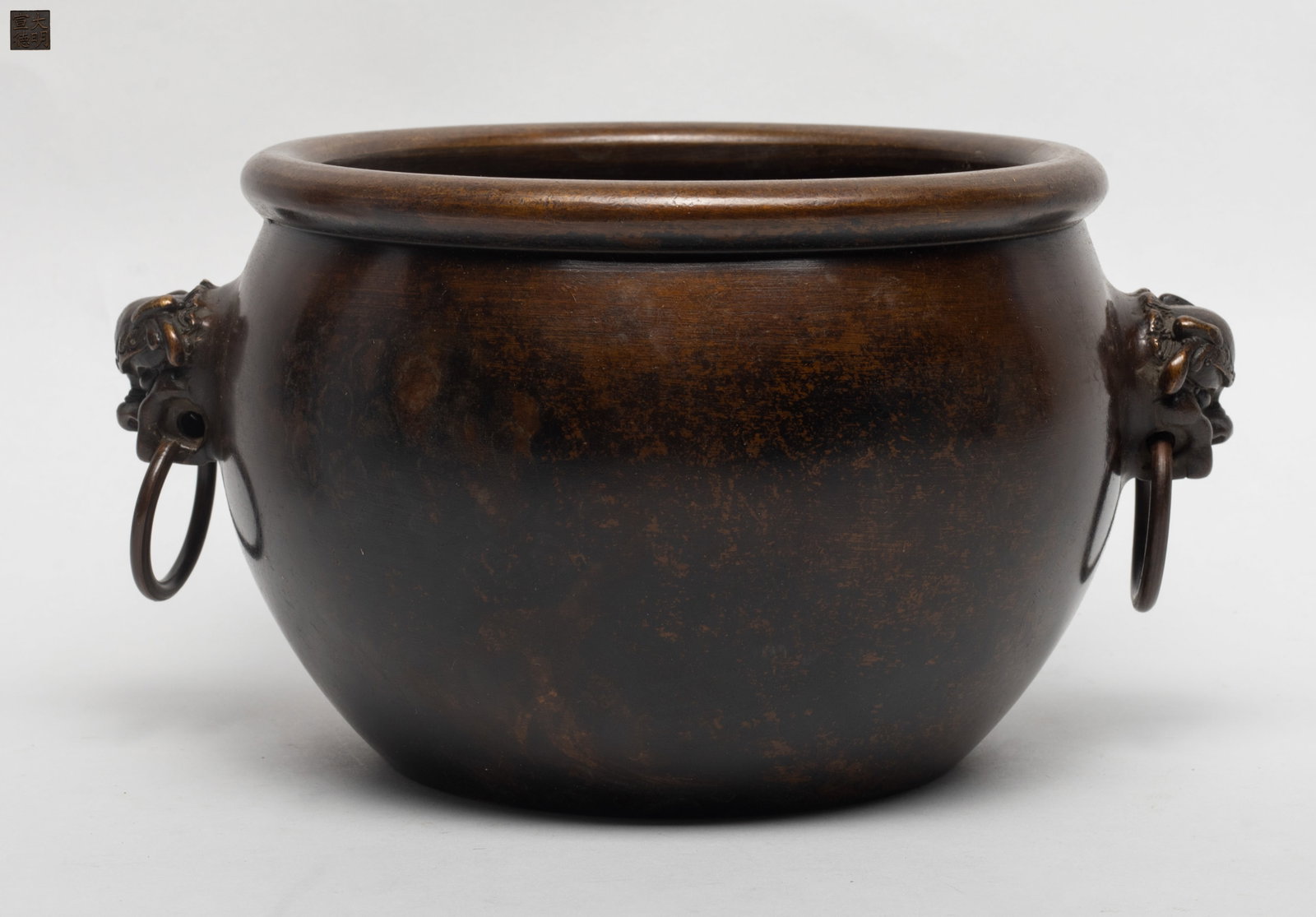 Estate Chinese Bronze Water Pot: Estate Chinese bronze water pot, the globular body flanked by a pair of beast head handle, mocked with rings, the base inscribed with a four character mark. Approx. 4.8*8.2 inch