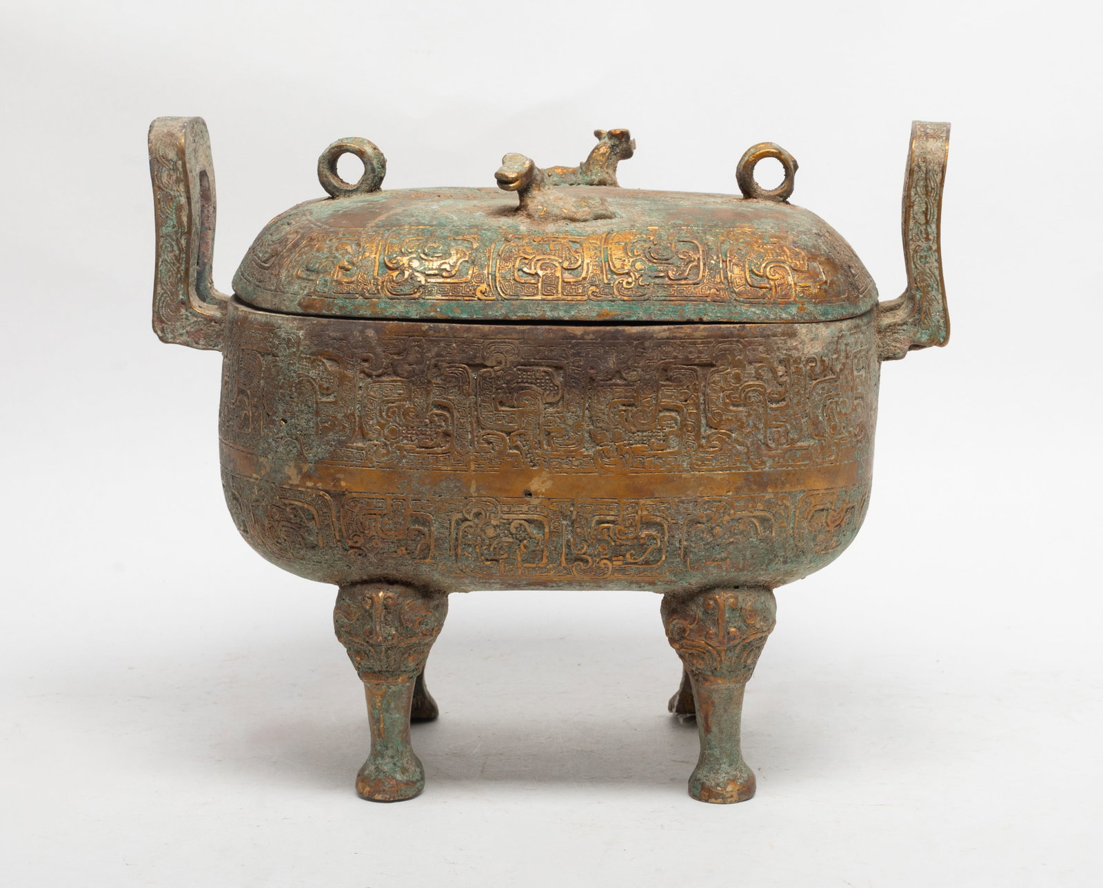 Large Chinese Gilt Bronze Covered Pot: The gilt bronze covered pot with a rectangular body , supported on a beast form legs, with upright loop handles, and the cover with two small beasts. Approx. 10.2*8.5 inch