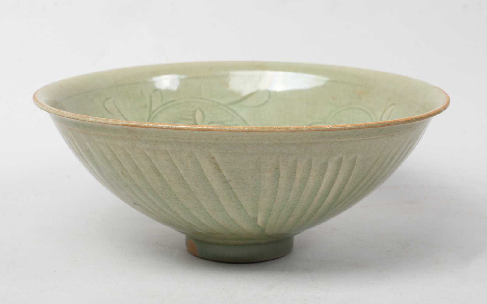 Large Chinese Shipwreck Type Porcelain Bowl: The bowl interior carved in low relief with undulating leafy stem issuing flowers, the exterior incised with radiating lines, overall covered with crackled celadon glaze. Approx. 7.6*3.1 inch.