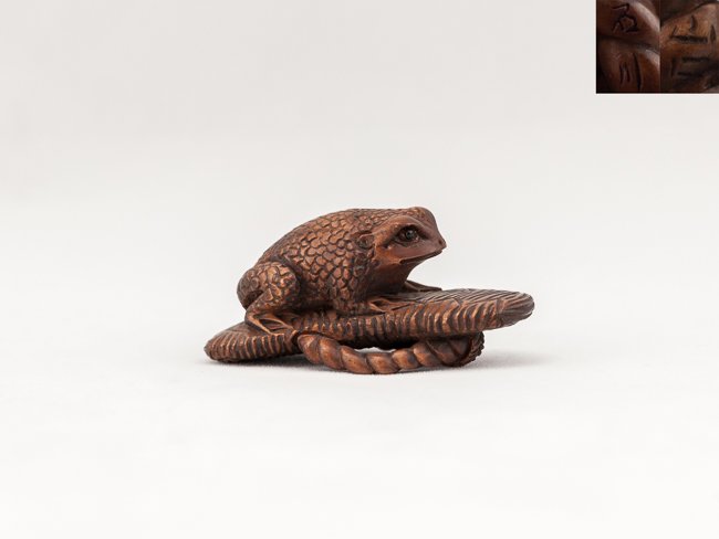 Antique Carved Box Wood Netsuke: Nicely carved antique box wood netsuke; of a toad seated squarely on a up-turned sandal with inlaid eyes, signed,5.7cm L,19th Century
