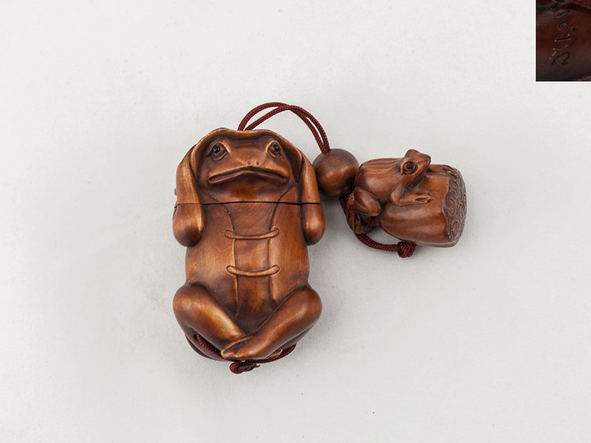 Antique Carved Box Wood Inro:Frog: Finely detailed carved 2 case box wood antique inro; of a seated frog wearing cloth holding a leaf over the head, inlaid eyes, the netsuke comes with it is a box wood carved frog sitting on a lotus ro