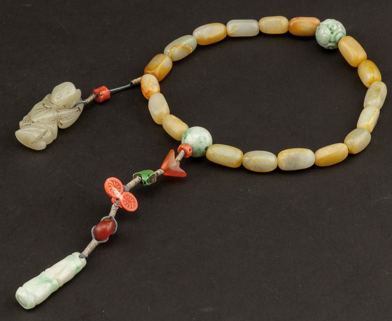Chinese Antique Jade Prayer Beads: Eighteen main beads spaced by two green jade beads, a carved white jade boy pendant suspending on the main beads, terminating in some carved agateand coral beads. 19th late Qing Dynasty. From the coll