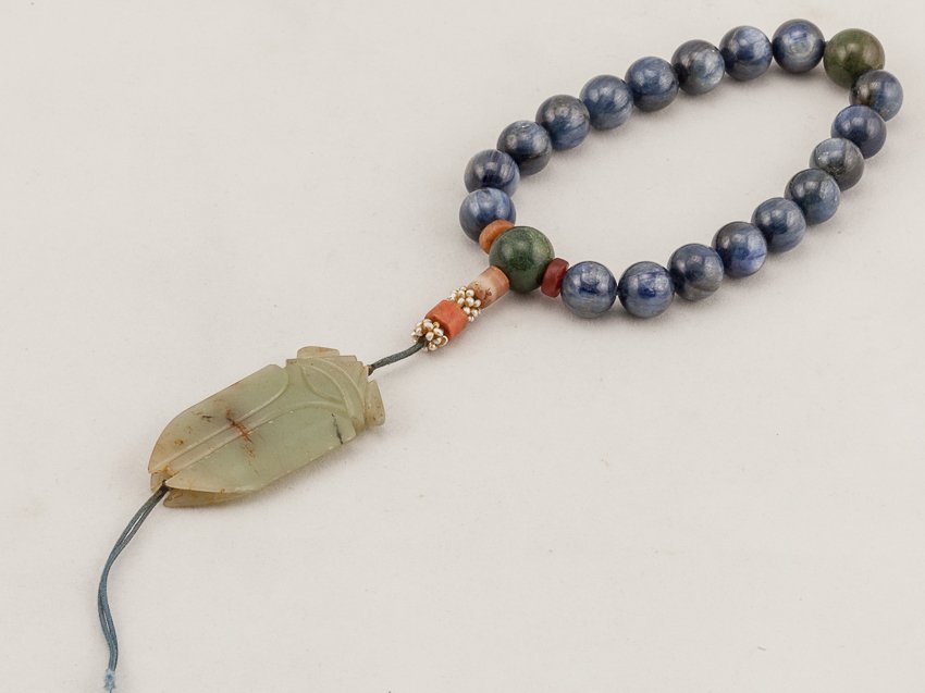 Chinese Antique Blue Gemstone Prayer Beads: Eighteen main beads spaced by two moss agate beads. A celadon jade cicada suspending on the beads. This is a nice and rare late 19th antique. From the estate of Mr.Maza.H.Laguana. The jade cicada is M