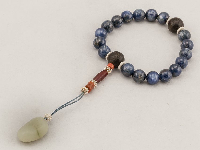 Chinese Antique Blue Gemstone Prayer Beads: Eighteen main beads spaced by shell spacers. A white jade suspending on the beads. This is a nice and rare late 19th antique. From the estate of Mr.Maza.H.Laguana. 1.2cm bead diameter