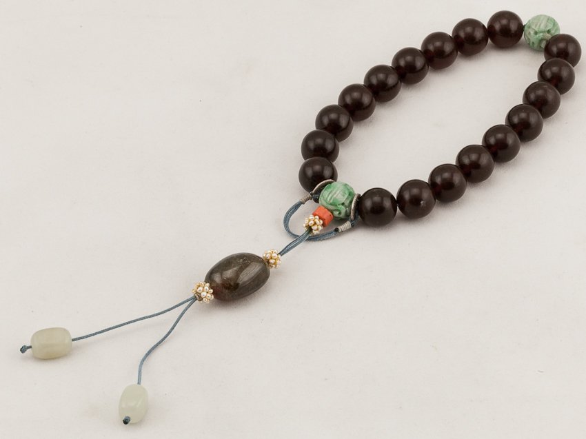 Chinese Antique Red Amber Prayer Beads: Beautiful beads comprising of eighteen red ambers as main beads, spaced by two green jade beads. It is a typical 19th century style. A nice yellow tourmaline as a central beads suspending on it.From a