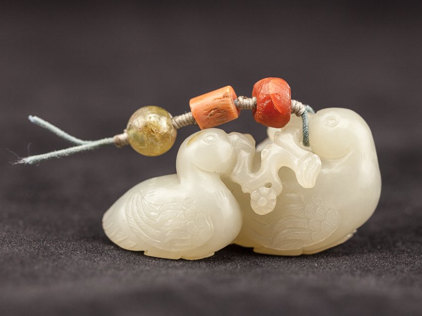 Chinese Antique White Jade Mandarin Ducks: 18TH white jade mandarin ducks; two white jade finely carved mandarin ducks seated side by side, holding a branch together with their mouths, finely incised fur curls, detailed carved claws, a tourmal