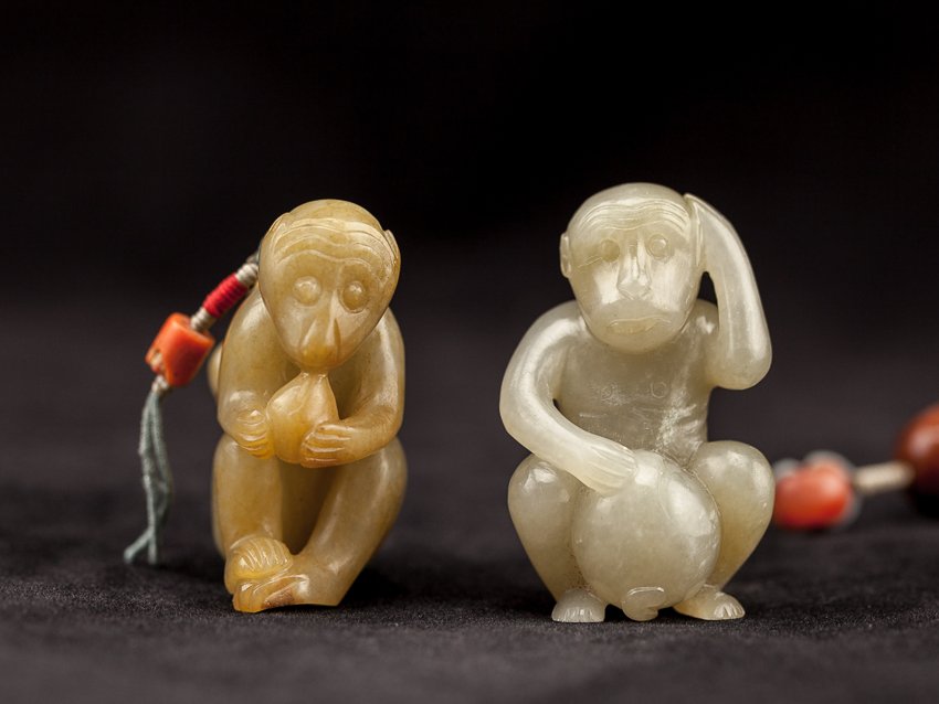 Set of Two Chinese Antique Jade Monkeys: Set of two late 18TH early 19TH jade monkeys; one monkey in greenish-color is seated with a peach between its legs, a string of multiple beads is attached to it, the yellowish-color jade monkey is sea