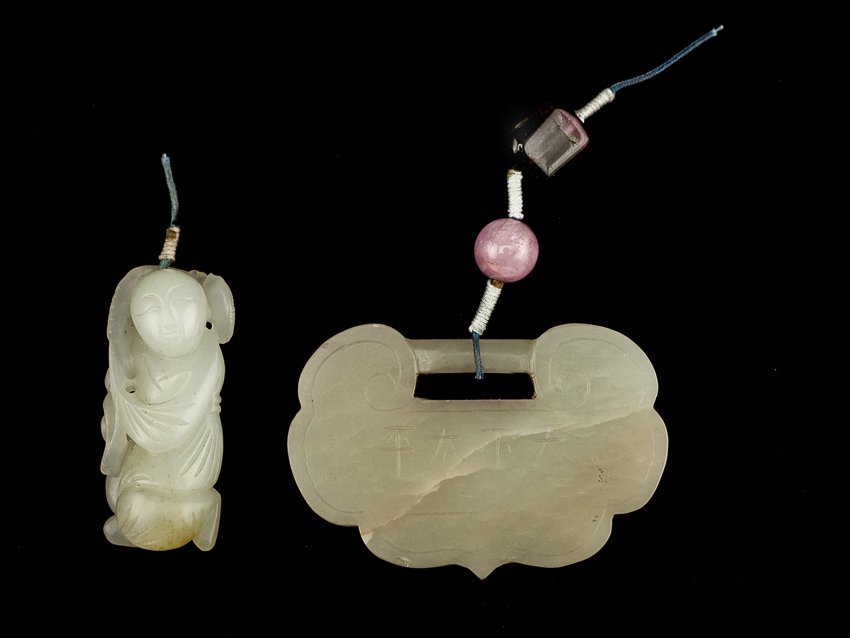 Set of Two Chinese Antique White Jade Pendants: Set of two 19TH white jade pendants; white color jade boy on bended knee holding a LimChi over his shoulder, the semi-translucent white color jade is carved as a lock with one-side carving a bat spitt