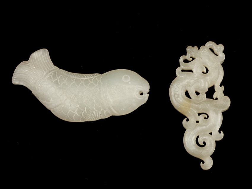 Set of Two Chinese Antique Jade Pendants: Set of two Late 19TH jade pendants; both in semi-translucent off white color, one carved as a curl up carp with a pierced hole forming the mouth, the other is carved as a dragon in vertical form, spir