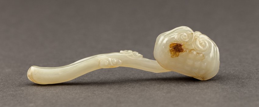 Chinese Antique 19TH Jade Ruyi: Jade limchi carved in a Ruyi from in white color jade. A bat in brown color is on the pad of limchi, at the bottom tip there are two small pieced hole for strings. Length: 11cm