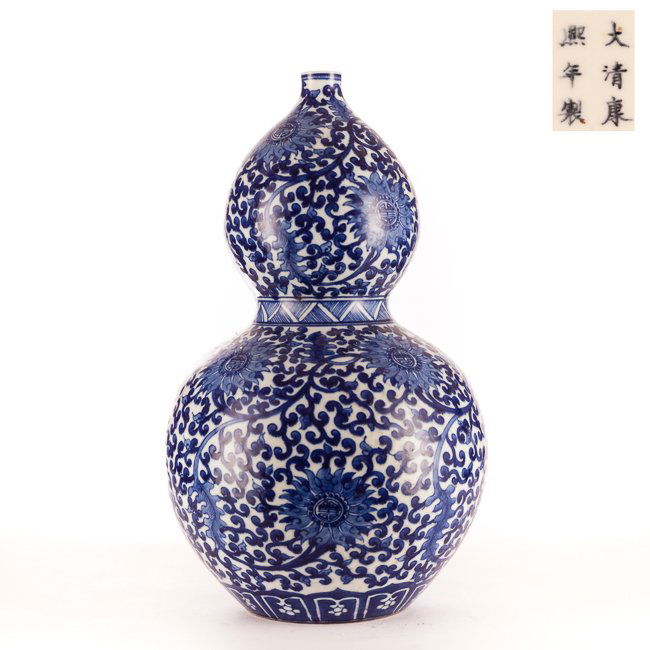 Chinese Antique Blue&White Porcelain Gourd Vase: Antique polished double gourd porcelain vase; the vase painted in blue and white depicting chrysanthen flower blossom intertwined with leafy tendrils; Kangxi mark but 19th copy. 14.5 inch H