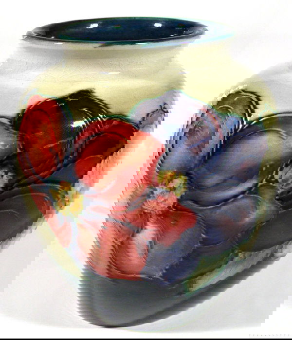 Moorcroft pottery vase hand painted and tubelined: Moorcroft pottery vase hand painted and tubelined with Clematis onto a blue ground, impressed factory mark and blue painted signature to the base, 13cm high