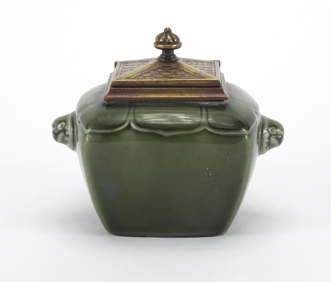 Aesthetic green glazed pottery inkwell by Theodore: Aesthetic green glazed pottery inkwell by Theodore Deck, with animalia handles and glass liner, 8.5cm high